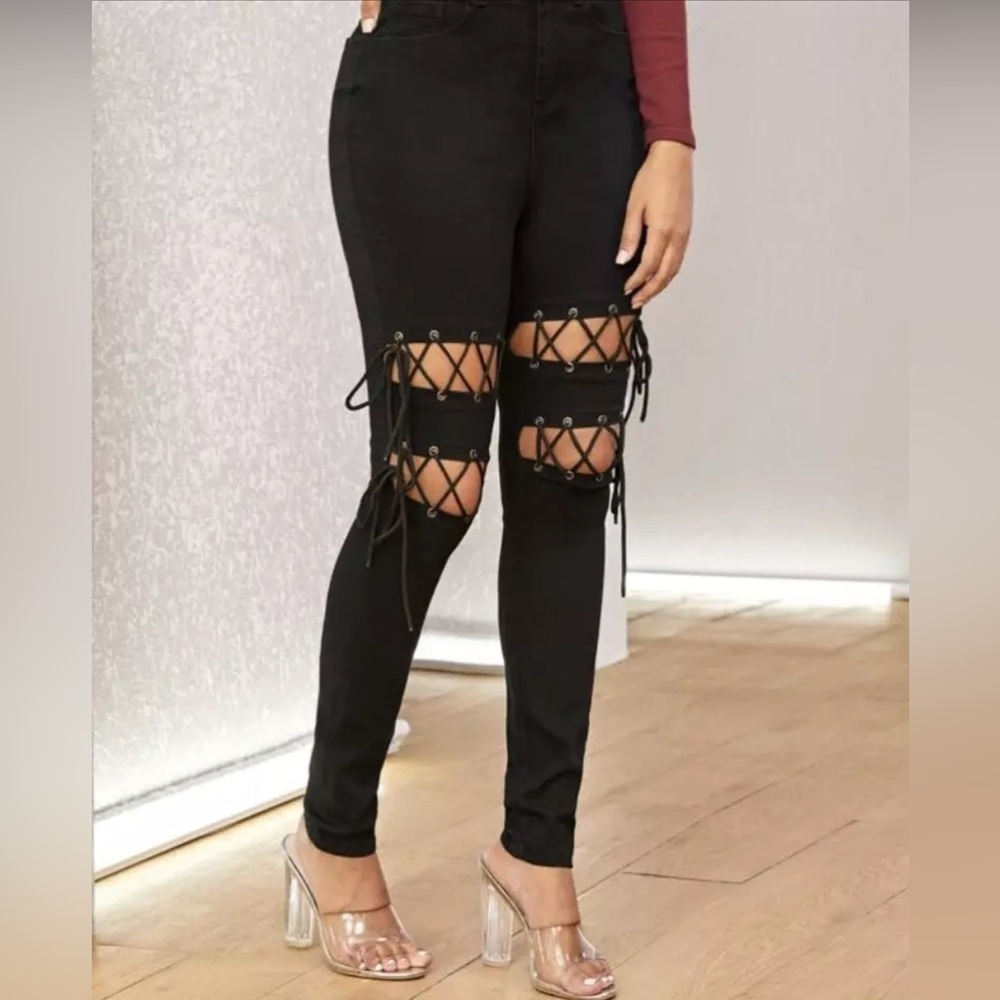 D2. Black high rise denim jeans, adjustable knee area with grommets, 2